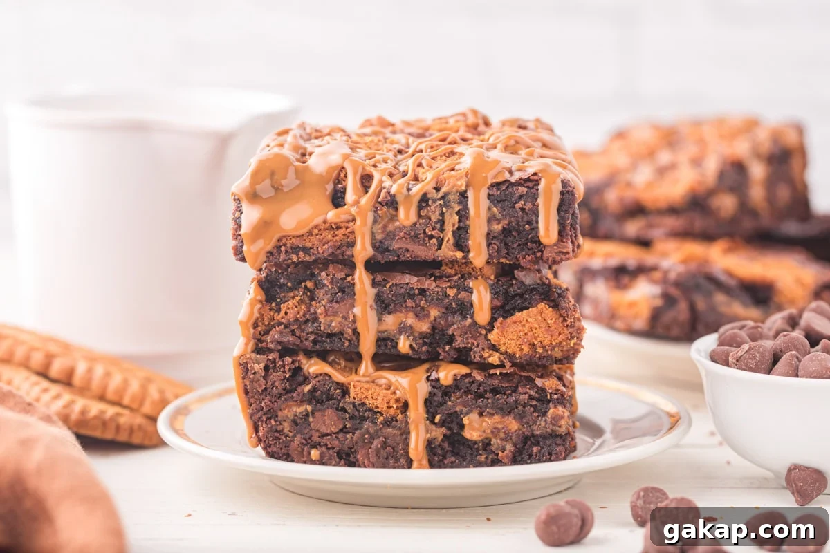 A stack of three brownies, topped with cookie butter.