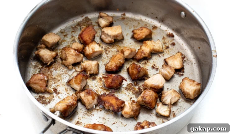 browning chicken bites in large silver skillet