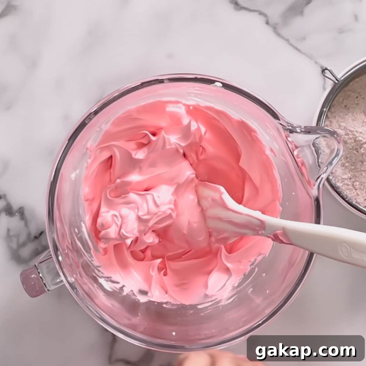 A glass bowl of pink meringue.
