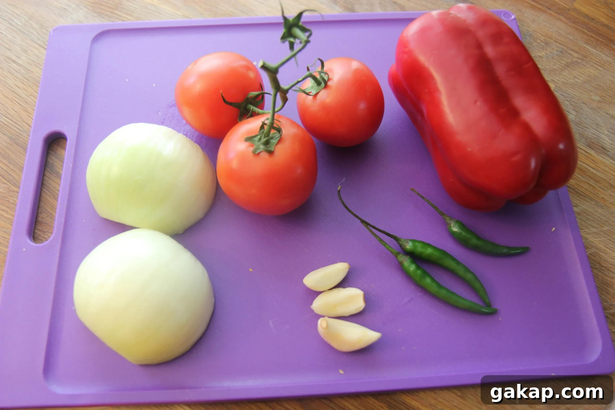 Spicy chicken tortilla soup ingredients on a purple cutting board.