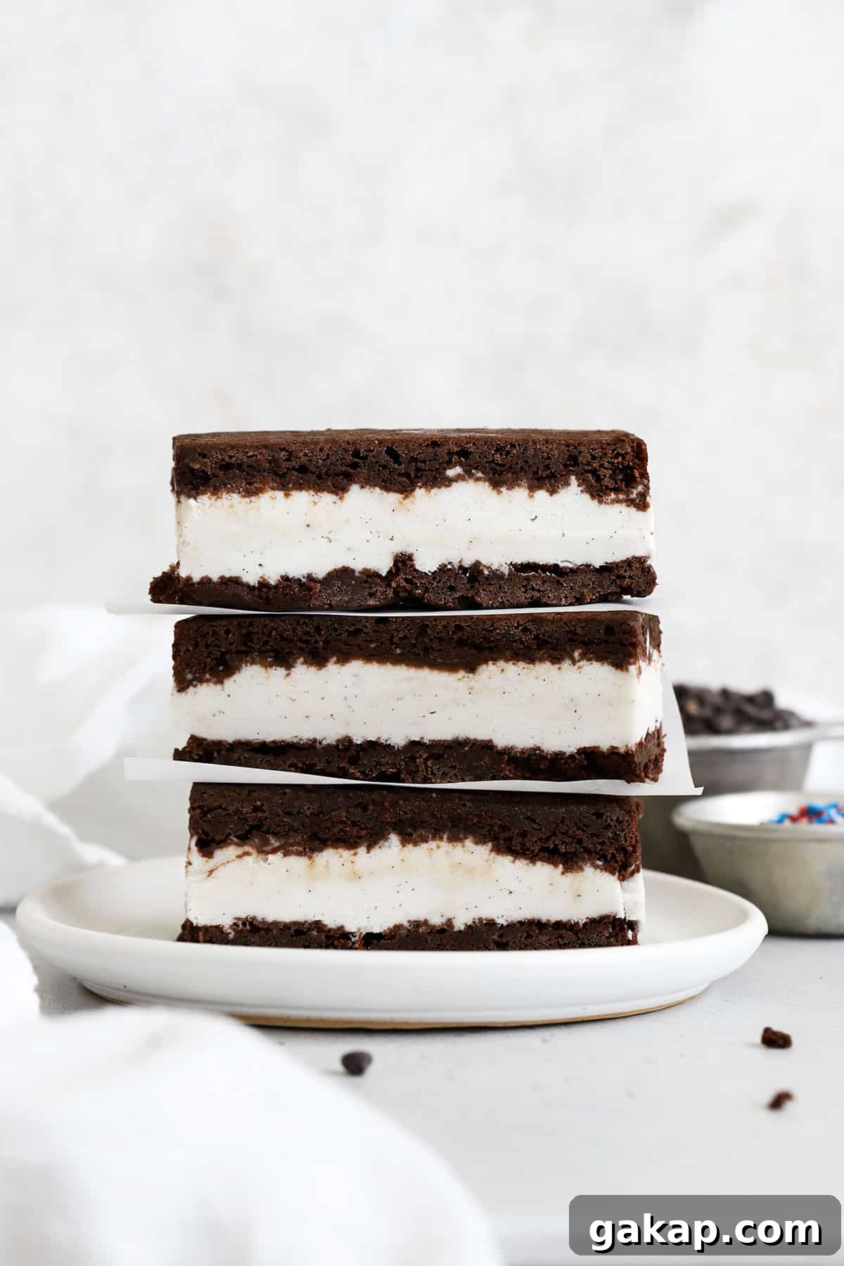 Gluten-Free Brownie Ice Cream Sandwich Recipe 2 three gluten-free brownie ice cream sandwiches stacked on a white plate