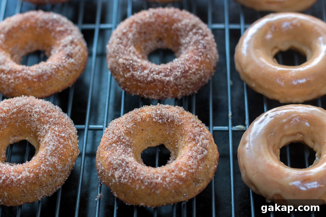 Baked donuts dipped in cinnamon sugar and maple glaze