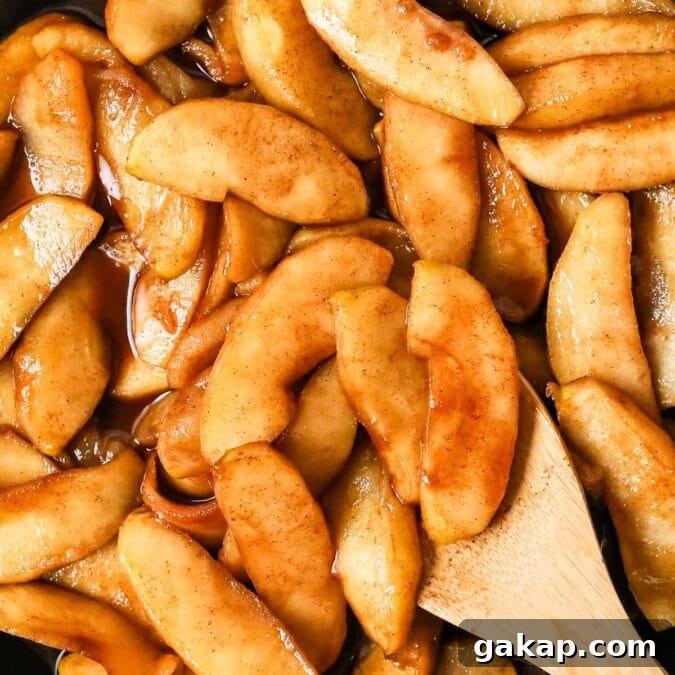 Overhead view of fried apples in a skillet.