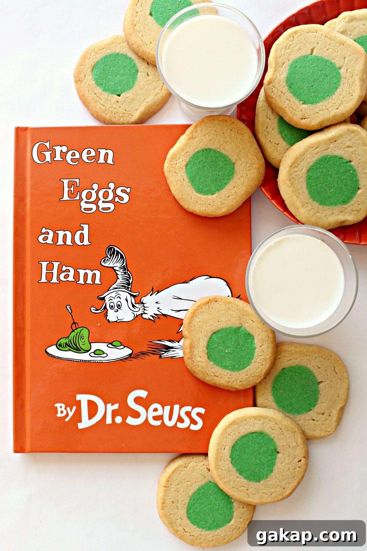 Green Eggs and Ham Sugar Cookies Inspired by Dr. Seuss 2 Green Eggs and Ham book with cookies with green circle centers and milk.