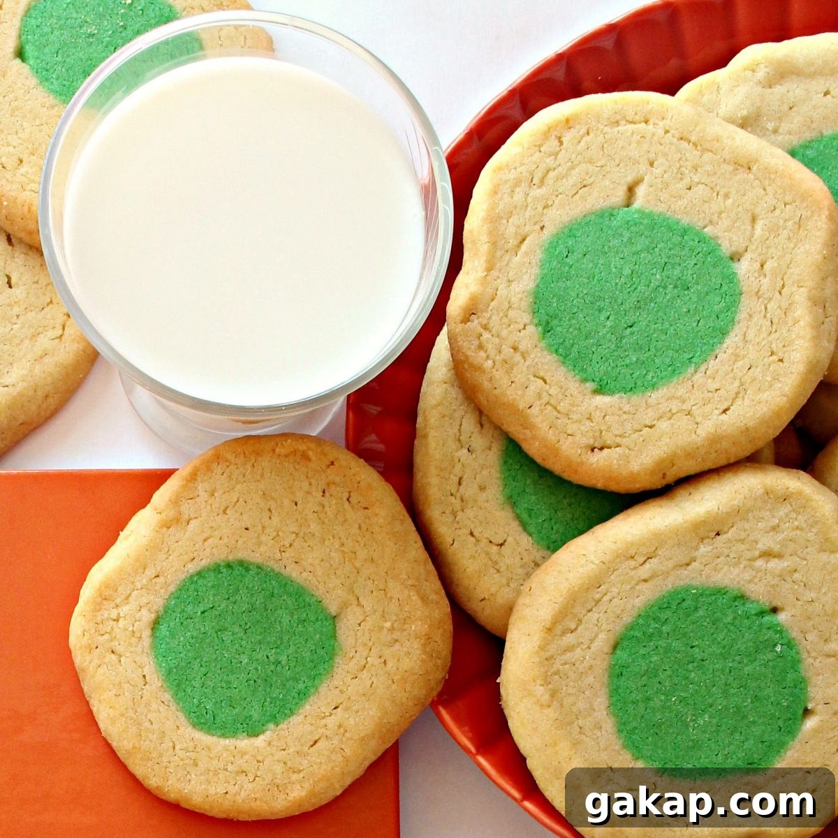 Green Eggs and Ham Sugar Cookies Inspired by Dr. Seuss 4 Green Eggs and Ham Cookies and glass of milk.