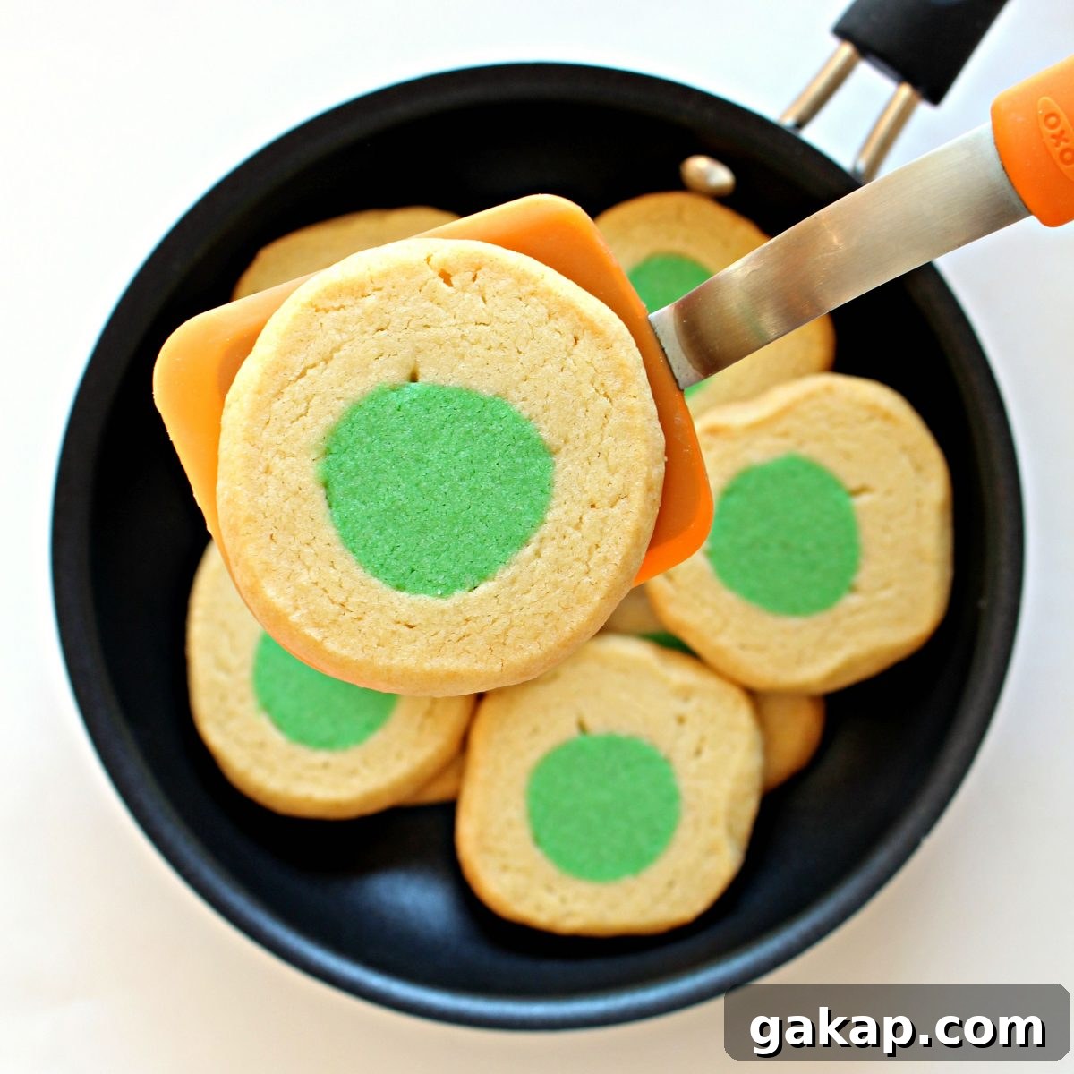 Green Eggs and Ham Sugar Cookies Inspired by Dr. Seuss 5 A cookie close-up on spatula.