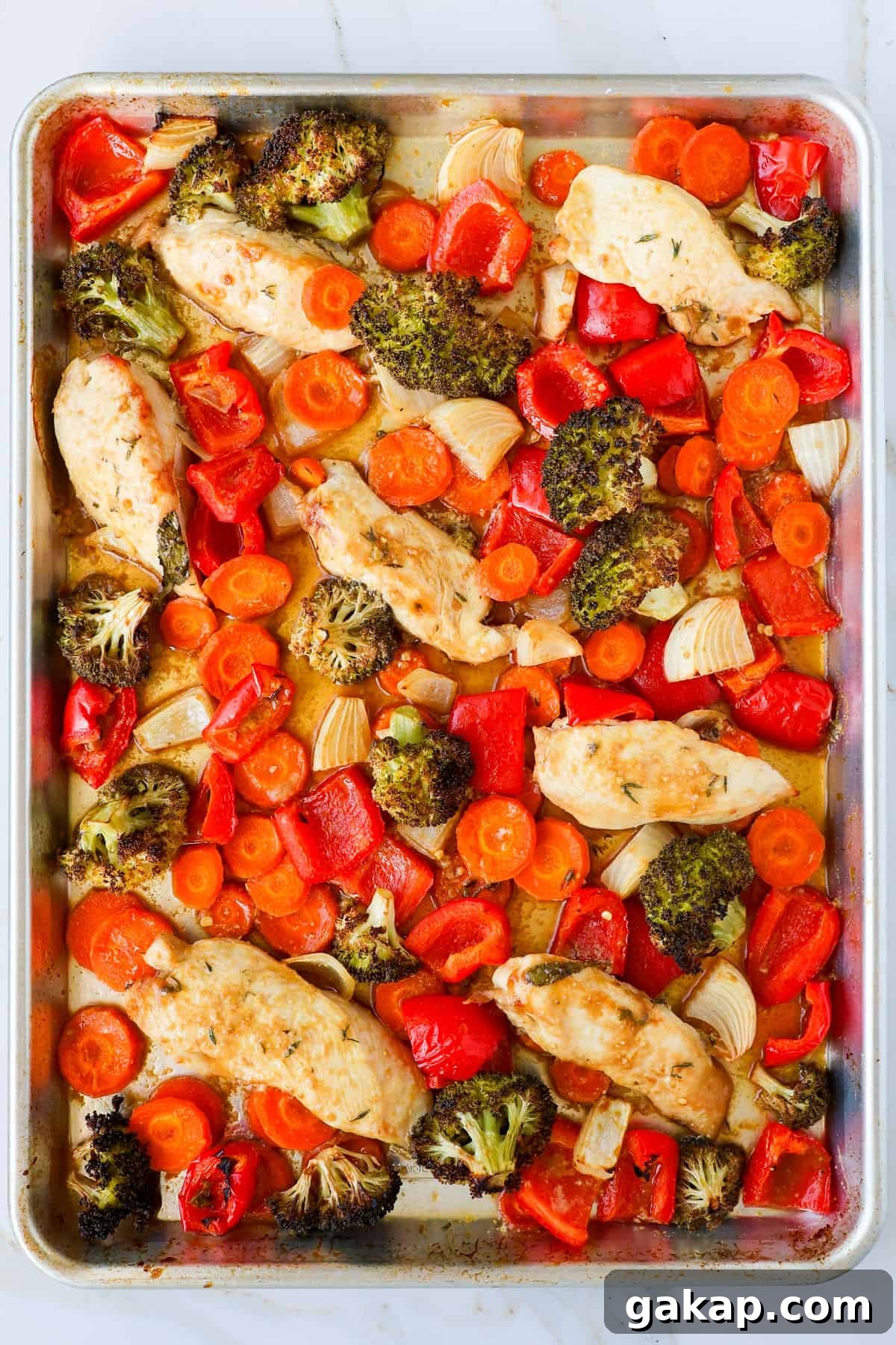 Baked chicken and veggies on sheet pan.
