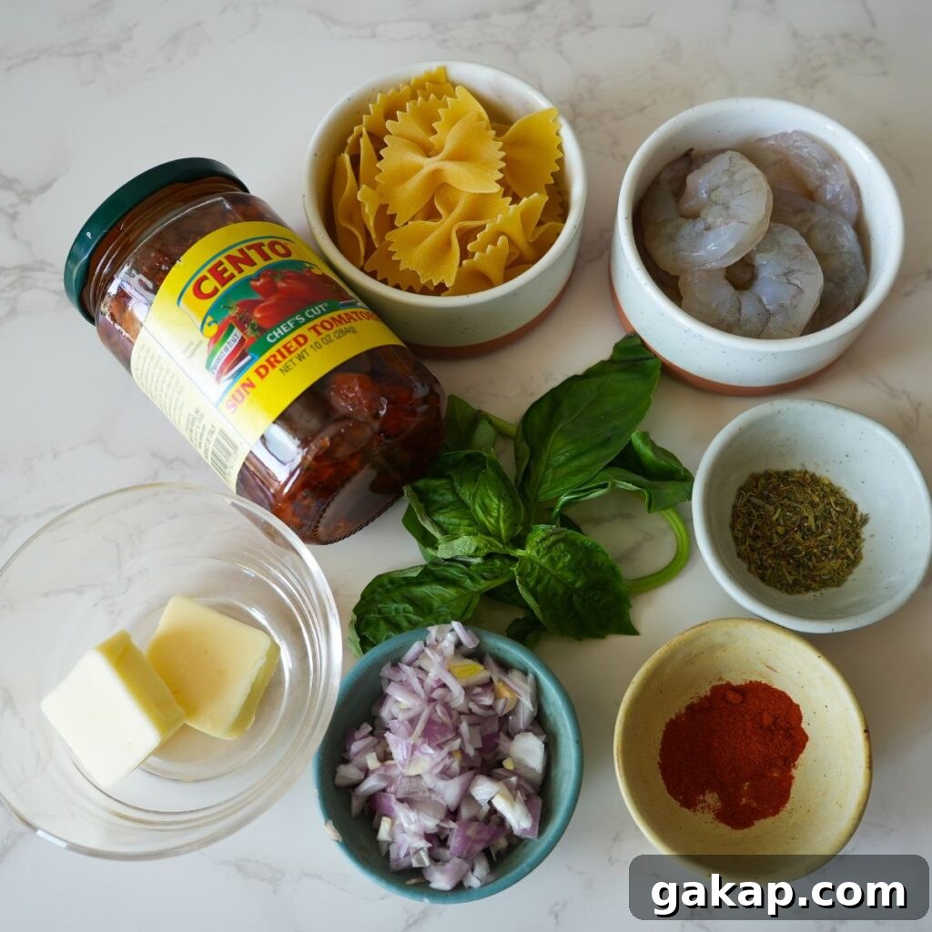 Ingredients needed for creamy sun dried tomato pasta. Sun dried tomato, pasta, shrimp, seasonings, basil, butter and shallots. 