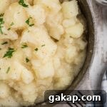 Comforting Stewed Potatoes Recipe with Garlic and Herbs 7 Close up shot of a pot of stewed potatoes.