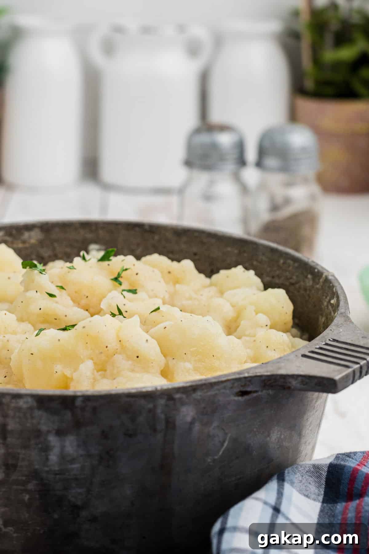 Comforting Stewed Potatoes Recipe with Garlic and Herbs 6 Side shot of the side of a pot of stewed potatoes.