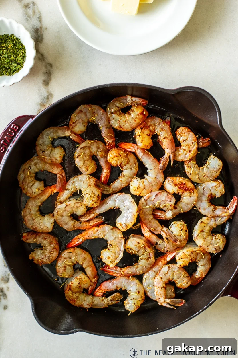 Up close overhead photo of a skillet of cooked shrimp