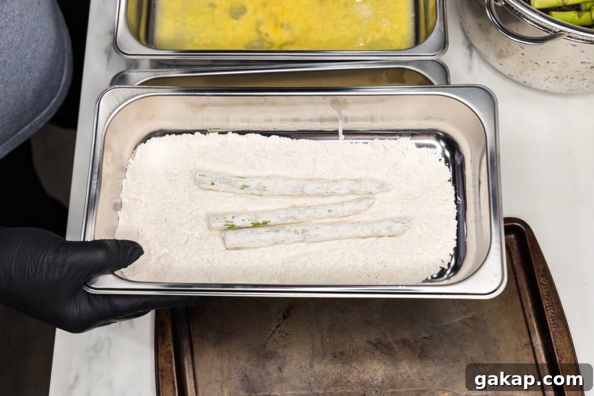 Crispy Pan-Fried Asparagus with Garlic and Lemon 8 dipping asparagus spears into flour