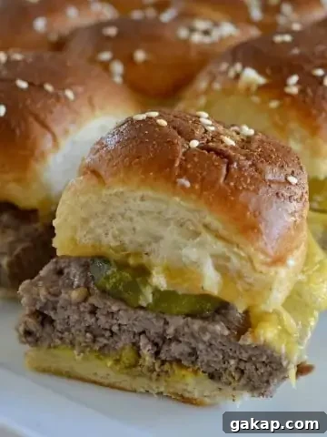 Easy baked cheeseburger sliders on a white plate.