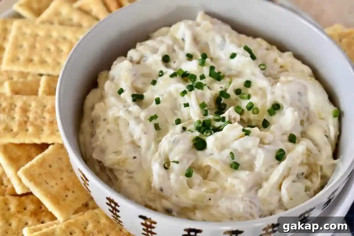 Dip in a bowl with crackers next to it. 