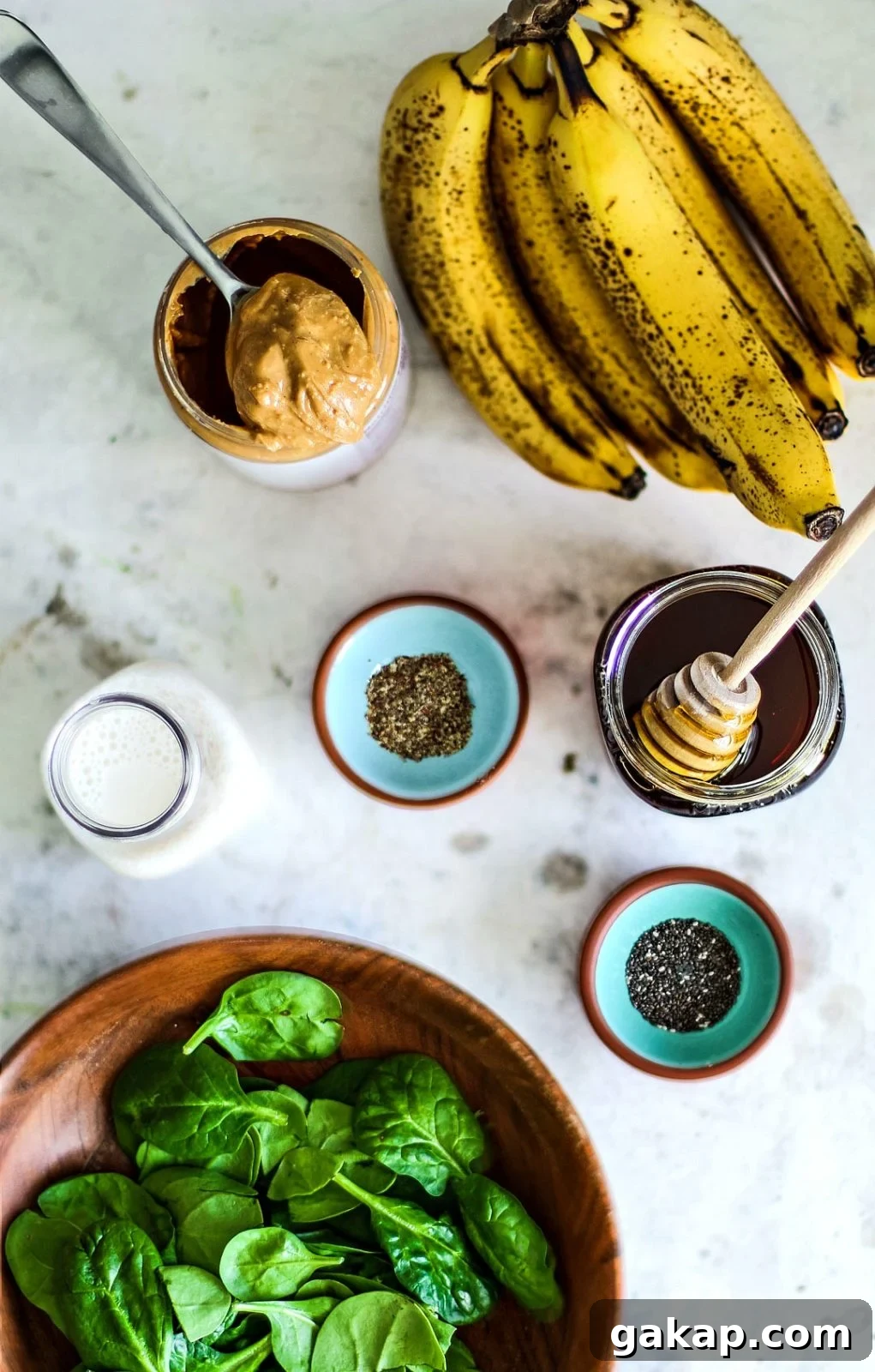 Peanut Butter Banana Spinach Smoothie ingredients on table.