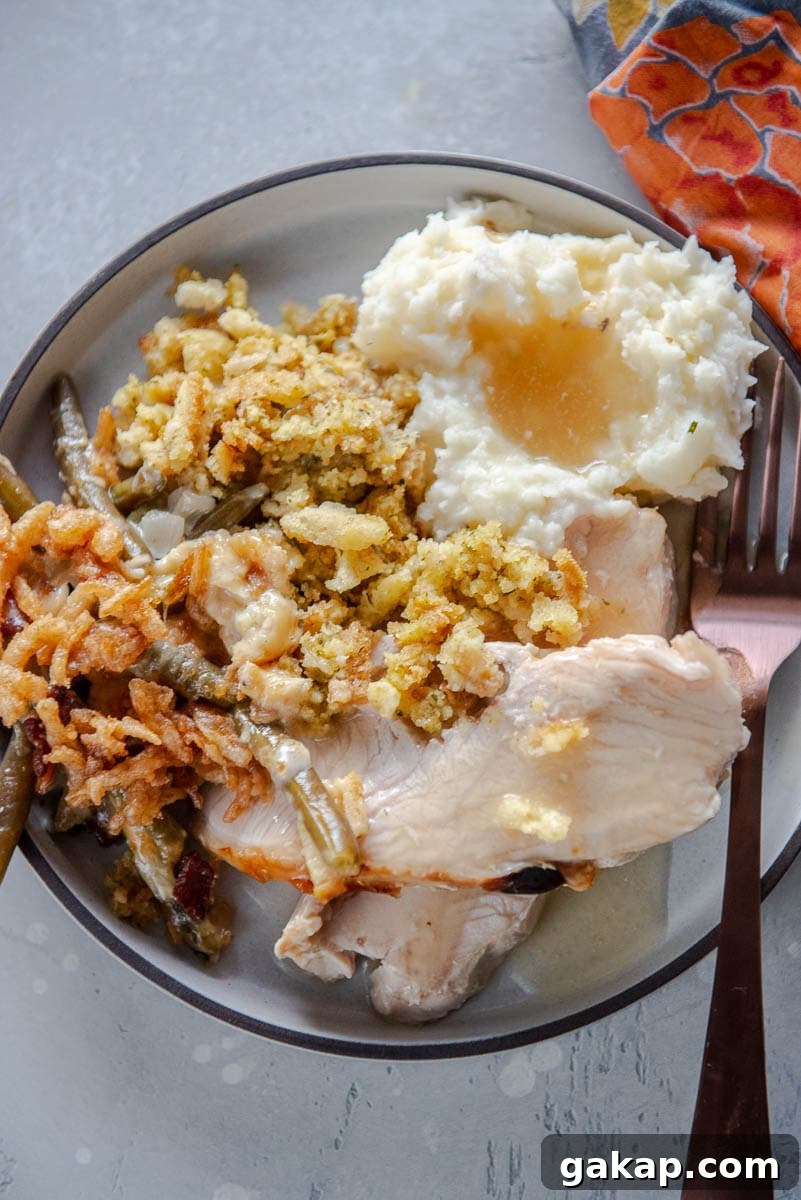 turkey, stuffing and mashed potatoes on gray plate