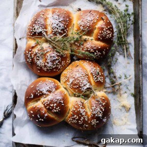 Bread rolls with seeds and herbs in a tray.