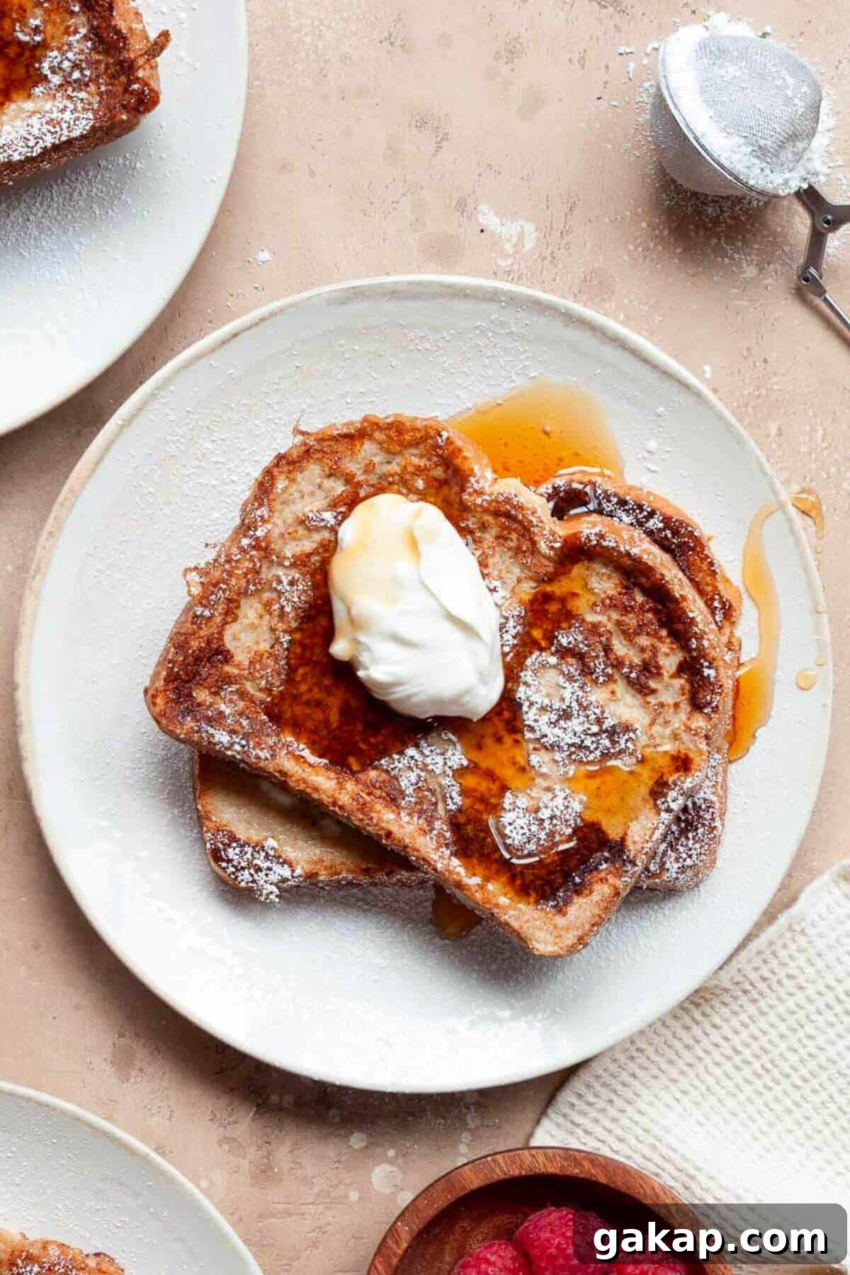 High protein french toast on a plate with syrup and greek yogurt on top.