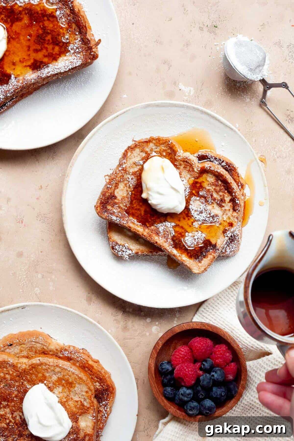 High-protein french toast on a plate with syrup and berries.