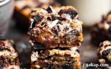 Gooey Small Batch Oreo Blondies stacked on top of each other next to a glass of milk