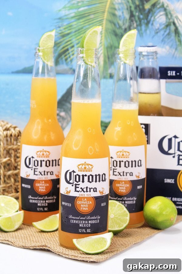 Three Corona beer bottles filled with a Corona Sunrise cocktail