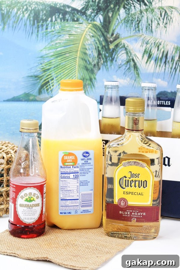 Tequila bottle, orange juice, grenadine, and beer on a beach background