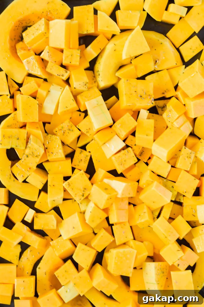 diced and cubed butternut squash on sheet pan ready to be roasted