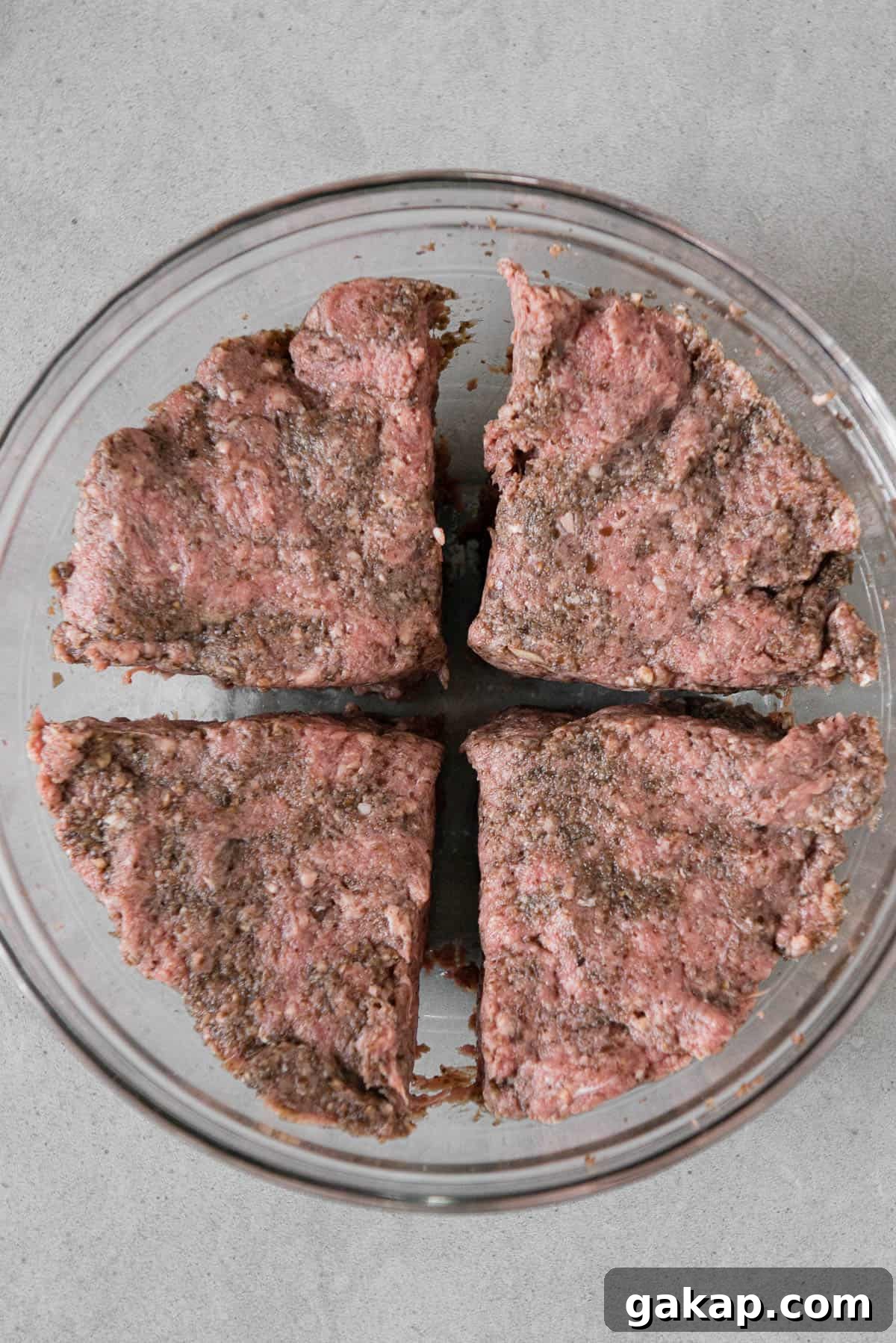 ground beef divided into four sections for hamburgers