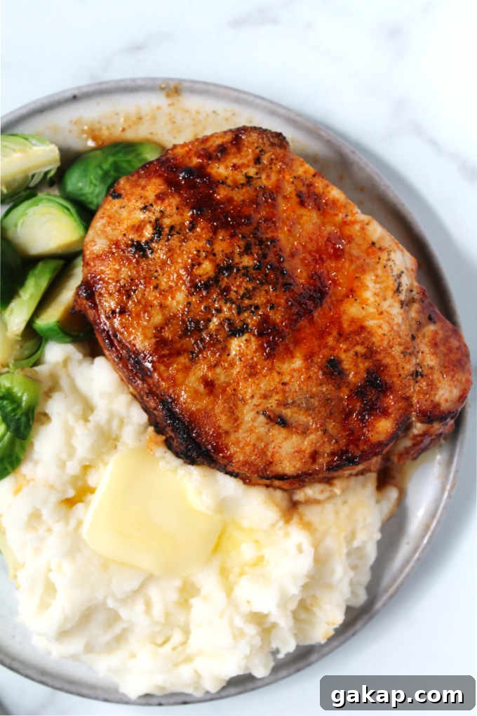 Overhead photo of chipotle air fryer pork chops with mashed potatoes and Brussels sprouts