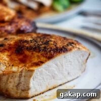 A chipotle air fryer pork chop sliced open to see the white meat.