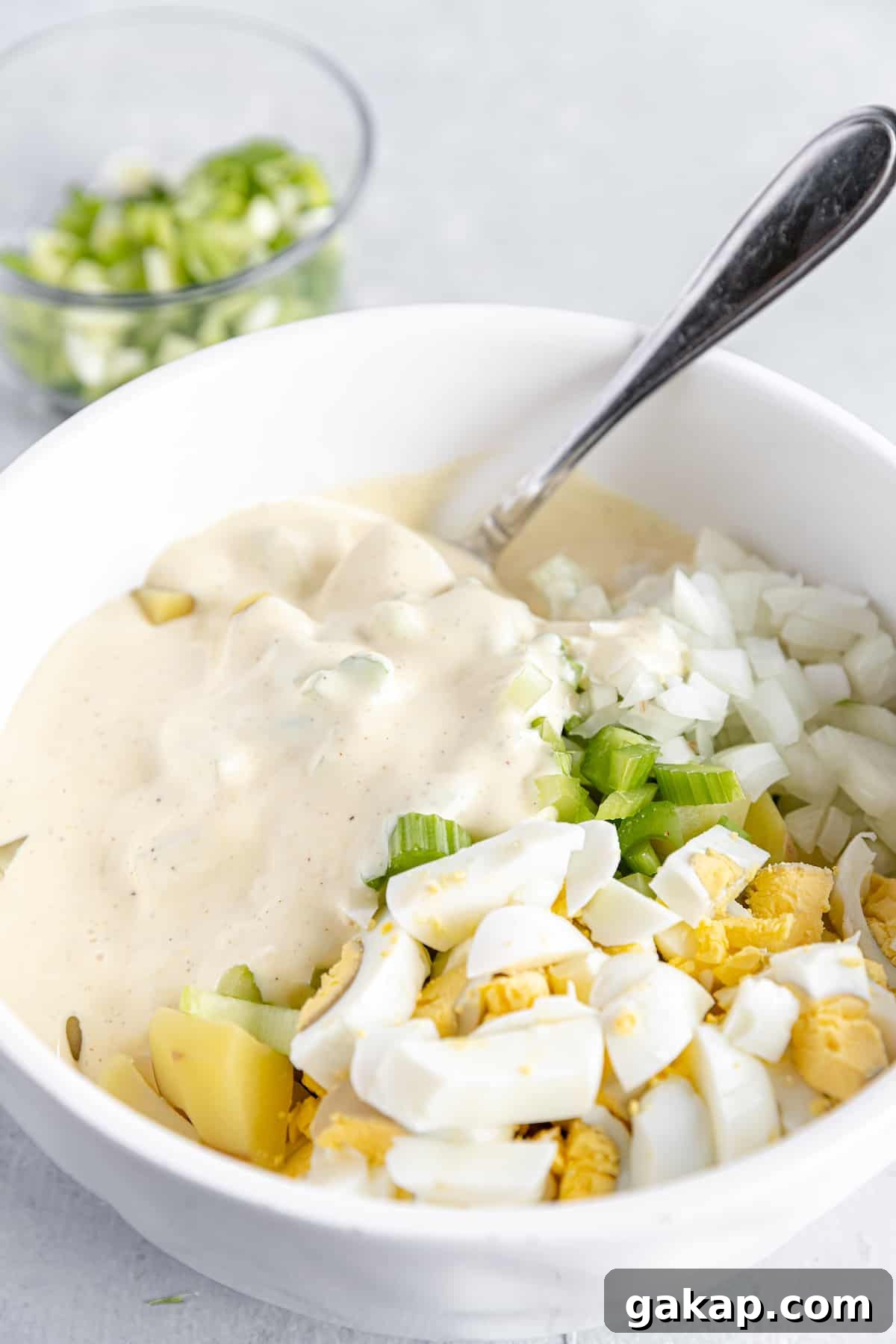 Mayonnaise Dressing Added Into the Bowl of Unmixed Potato Salad Ingredients