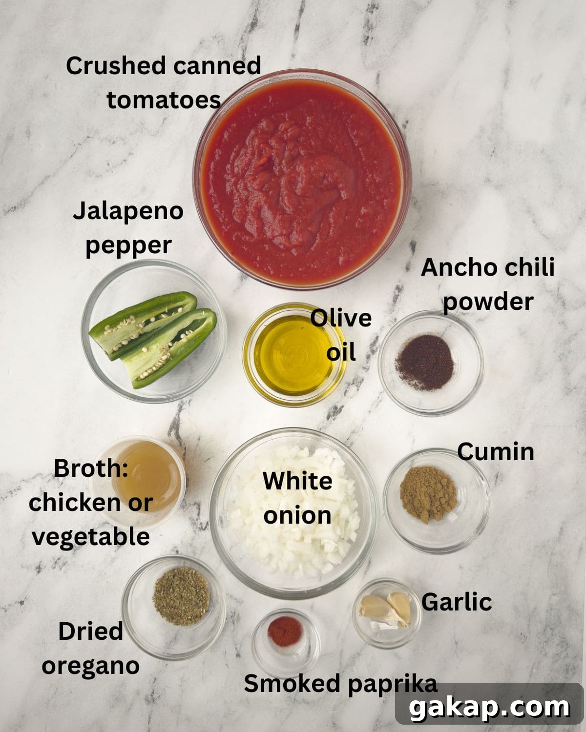 Ingredients for Mexican Ranchero Sauce with tomatoes, peppers, spices, onion, and more.
